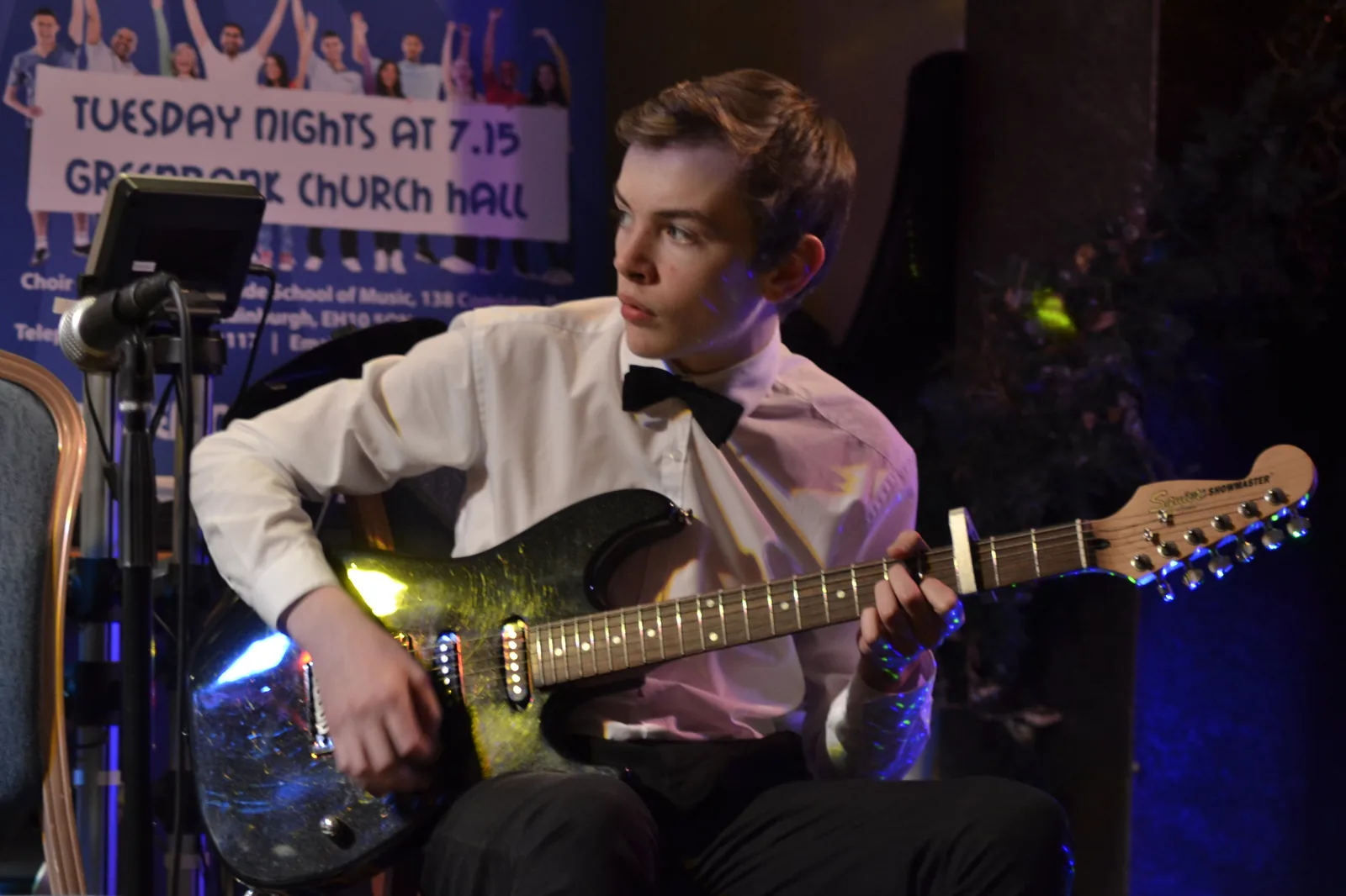 A Morningside School of Music student performing electric guitar at a charity concert in Greenbank Church Hall A Morningside School of Music student performing electric guitar at a charity concert in Greenbank Church Hall