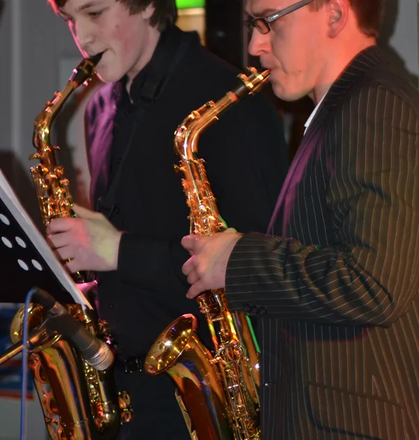 An adult and teenage saxophone student performing together at Morningside School of Music