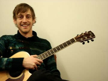 Edinburgh Guitar Lessons – Fun, Professional Tuition for All Ages | Morningside School of Music One of our local, friendly, guitar tutors with his acoustic guitar.